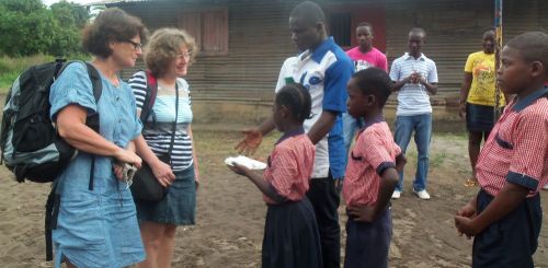 Child presenting white kola nuts to welcome the guests traditionally