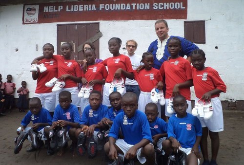 Guests posing with students in their new jerseys