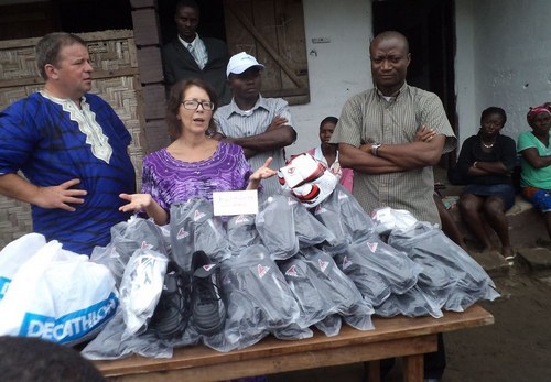 Lena making remarks after presenting the 25 pairs of boots to the school