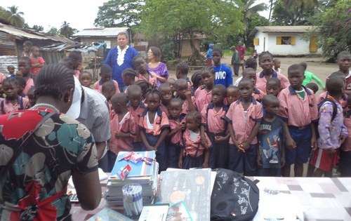 Staff viewing gifts, as guests and students look on