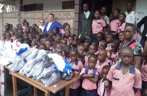 Students, guests and staff pose behind gifts