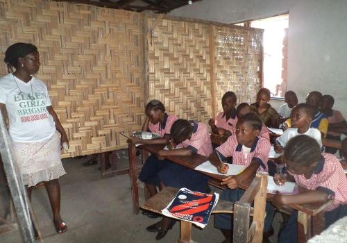 Female teacher Philemina teaching in class