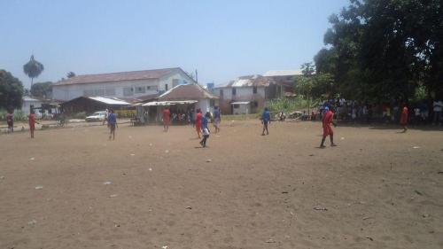 Our boys and the boys of James Teah School playing on the field
