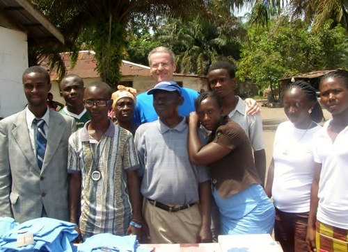Roger posing with staff after his donation to them