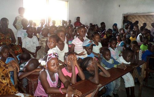 Cross-section of students praying before the start of the program