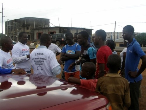 A few of my colleagues talking with a group of young people about Ebola safety measures