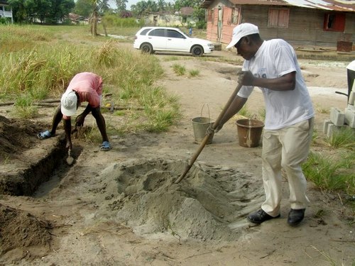The Vice Principal for Instructions, Mr. Andrew Garsuah, helping to mix the concrete