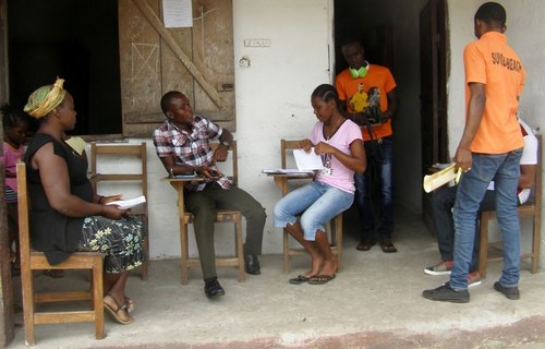 Parents receiving grade sheets from teachers