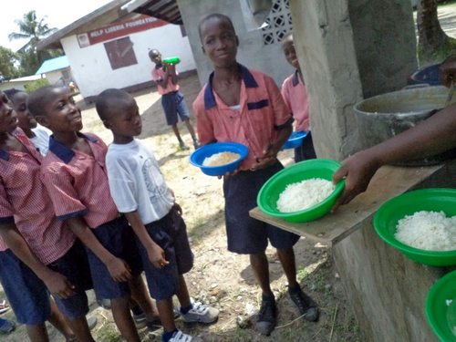 Kids in line for food at the kitchen