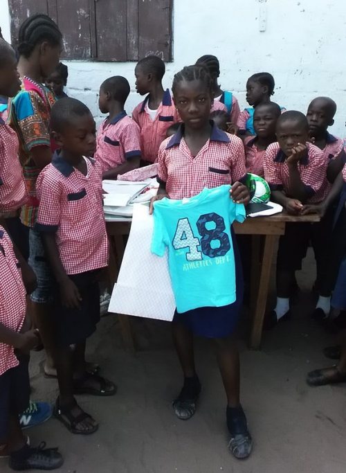 Felecia displays the t-shirt from her parcel