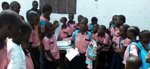 Kids and staff viewing and displaying some of the donated items