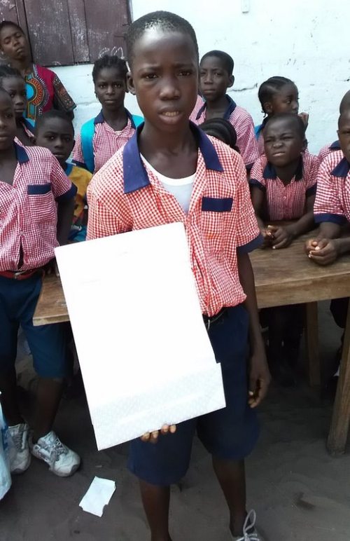 One of Elizabeth sponsored children displays his parcel