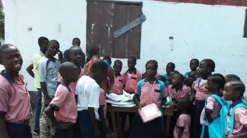 Susan displays her parcel as other kids look on