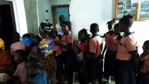 Students waiting in line to receive food after the program