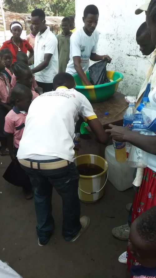Staff members measuring food ration for kids