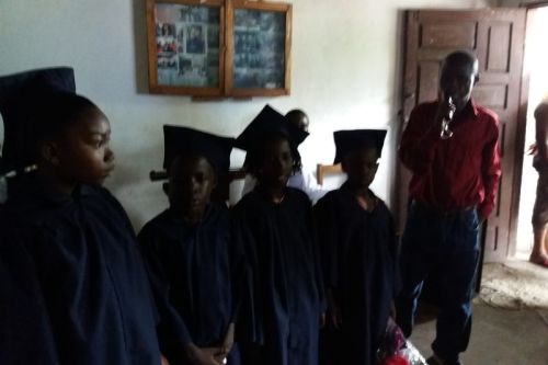 The four kindergarten graduates being presented to the audience